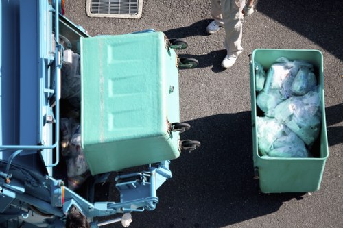 Man and van team loading waste in a busy East Ham street